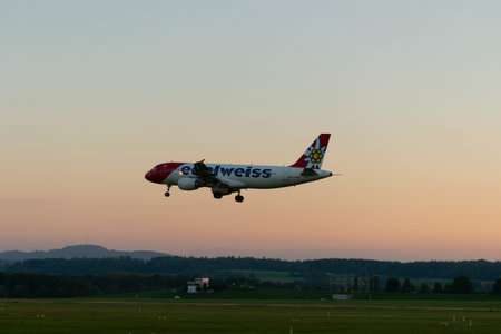 Zurich, Switzerland, September 6, 2023 HB-IJW Edelweiss Air Airbus A320-214 aircraft on its final approach to runway 14 in the eveningのeditorial素材