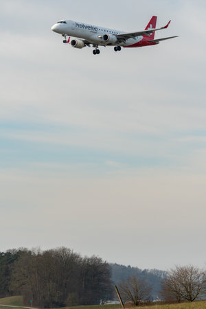 Zurich, Switzerland, January 16, 2024 HB-JVO Helvetic Airways Embraer E190-LR aircraft on its final approach to runway 14のeditorial素材