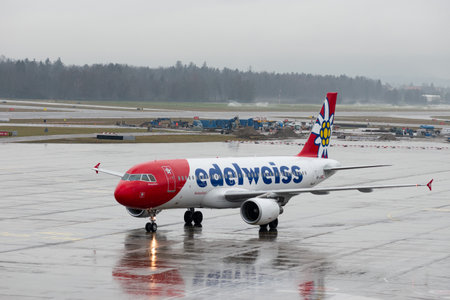 Zurich, Switzerland, January 17, 2024 HB-JJN Edelweiss Air Airbus A320-214 aircraft is taxiing over the apron during a rain showerのeditorial素材
