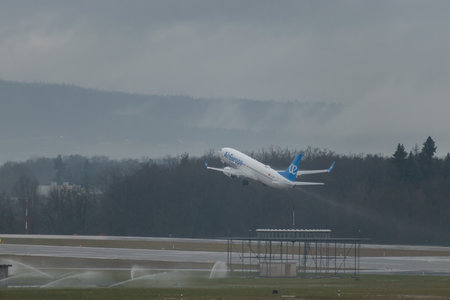 Zurich, Switzerland, January 17, 2024 EC-OBP Air Europa Boeing 737-8JP aircraft is departing from runway 28 during a rain showerのeditorial素材