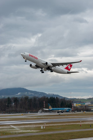 Zurich, Switzerland, January 17, 2024 HB-JHC Swiss international airlines Airbus A330-343 aircraft is leaving from runway 16 on a rainy dayのeditorial素材