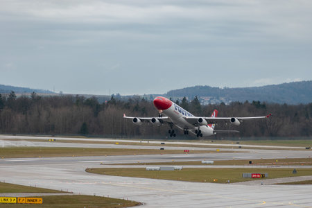 Zurich, Switzerland, January 17, 2024 HB-JMF Edelweiss Air Airbus A340-313X aircraft is taking off from runway 16 on a rainy dayのeditorial素材