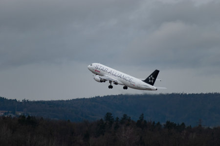 Zurich, Switzerland, January 18, 2024 HB-IJO Swiss Star Alliance Airbus A320-214 aircraft is taking off from runway 28 during a rain showerのeditorial素材
