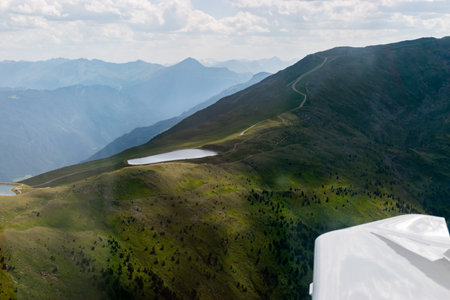 Tyrol, Austria, July 30, 2024 Beautiful Frommes lakes in an alpine scenery during a flight in a small planeの写真素材