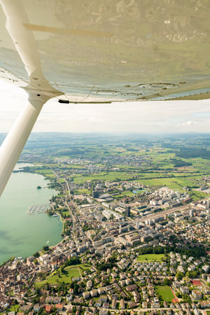 Zug, Switzerland, August 19, 2024 View over the city during a flight in a small plane