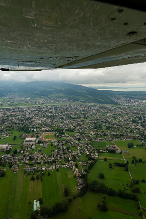 Lustenau, Austria, August 19, 2024 View over the village and the border region to Switzerland during a flight in a small planeの写真素材