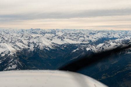 Sonthofen area, Germany, September 29, 2024 Majestic snow covered alpine scenery during a flight in a small planeの写真素材