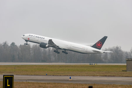 Zurich, Switzerland, January 23, 2026 C-FIUL Air Canada Boeing 777-333ER aircraft is taking off from runway 28 on a very foggy dayのeditorial素材