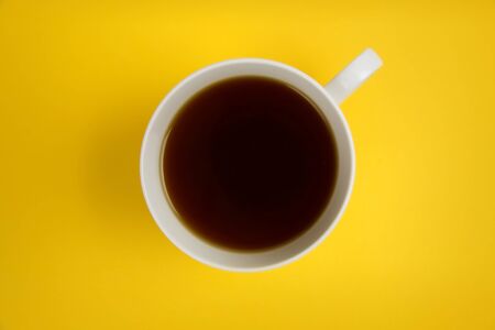 cup of coffee yeallow backgroundの写真素材