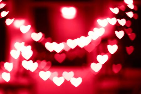 blurred floating hearts on red backgroundの写真素材