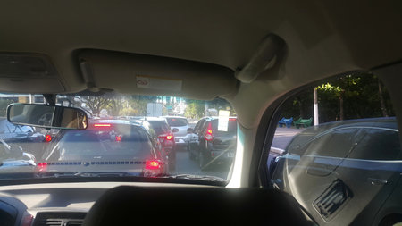 Congested traffic with many cars on a clear afternoon