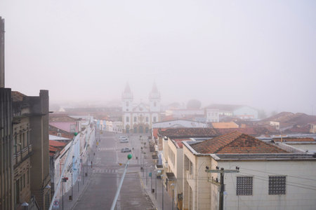 View of an inland town with ancient architecture on a foggy dayの写真素材