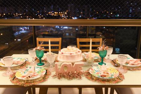 Beautiful arrangement of a dining table with beautiful plates and bowls on an apartment balcony