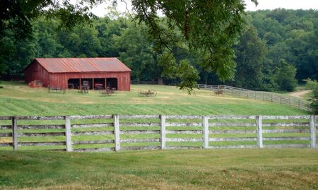 Lawson, Missouri - July 10, 2010: Watkins Woolen Mill State Historic Site red barn and fence
