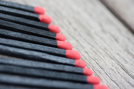 Black matches on wooden texture backgroundの写真素材