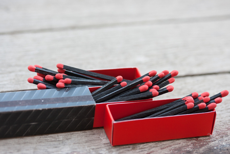 Black matches on wooden texture backgroundの写真素材