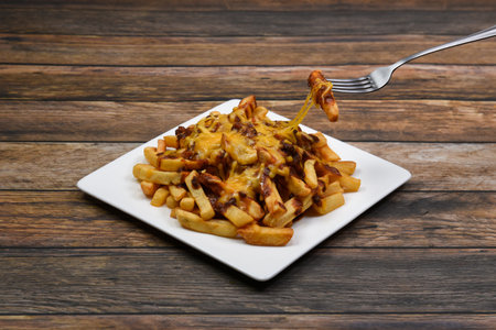 A plate of delicious chili cheese fries.
