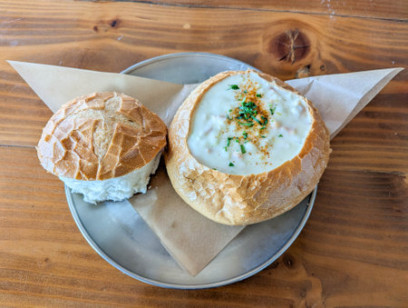 A delicious helping of clam chowder served in a sour dough bowl.の写真素材