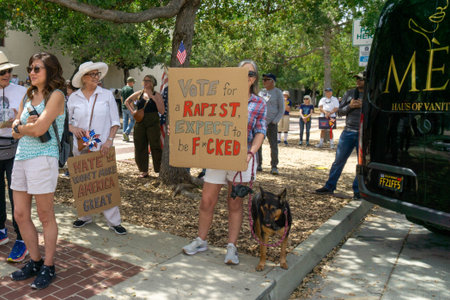 A woman hold up a strongly worded sign at the No Kings rally in Pasadena CA