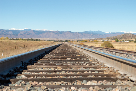 Low angle view of railroad track leading to the Rocky Mountainsの写真素材