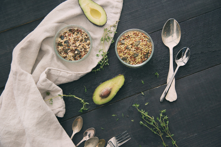 Healthy porridge with seeds and legumes on black board with avocadoの写真素材
