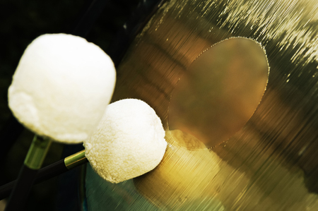Close-up of golden gong and percussion mallets