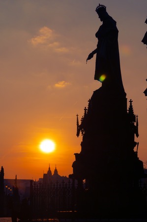 Silhouette of Charles IV statue nearby Charles bridge - Karluv most, in Prague at sunsetの写真素材