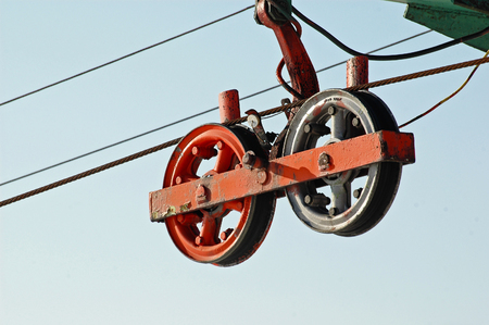 Closeup of old weathered ski lift pulley and steel cablesの写真素材