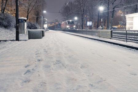 Ljubljana, Slovenia - December 12, 2019: Passing freight train at Ljubljana Tivoli train station on a snowy nightのeditorial素材