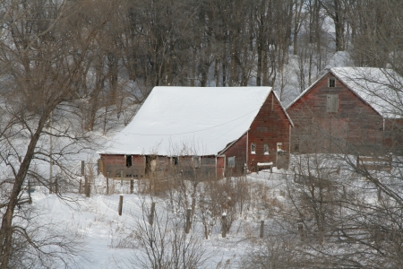Winter scene of old barns and farm yard covered in snow のeditorial素材