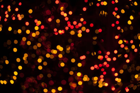 Yellow and red Christmas lights taken slightly out of focusの写真素材