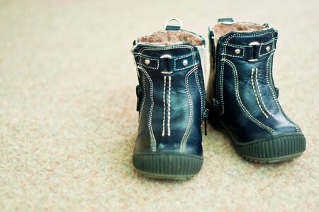 Pair of blue leather winter boots for children の写真素材