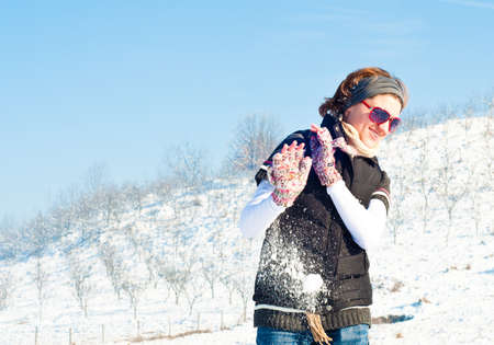 Young woman with red sunglasses in a snow fightの写真素材
