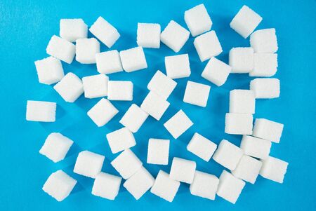 sugar cubes on a blue background. diabetes mellitus. Sweets. Strict dietの写真素材