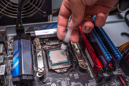 Replacement of thermal paste on processors, computer repair and PC improvement. components for the personal computer. computer system upgrade. Uzhhorod. Ukraine - June 22. 2020のeditorial素材