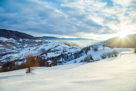 Beautiful sunrise over the snowy mountains. Winter season.