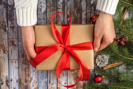 girl holding a gift box on a Christmas background. Merry Christmas.