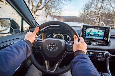 Uzhhorod, Ukraine. January, 2021. Gray car of the Japanese brand Toyota RAV 4 hybrid. SUV, crossover. Reliable and beautiful car. Car in the winter mountains.のeditorial素材