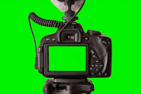 camera isolated on green background. Green screen background. Video blog concept. video camera.の写真素材