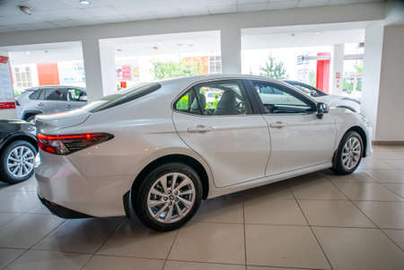 Uzhhorod, Ukraine. January 2021 white car of the Japanese brand Toyota CAMRY hybrid. Sedan, business. Reliable and beautiful car. The car in the cabin.のeditorial素材