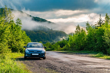 Vilshanky, Ukraine. April 24, 2021. car on a background of morning fog in the mountains. Travel concept.の写真素材