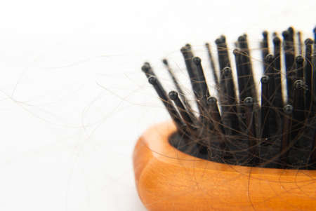 hair loss. wooden comb with burnt hair from stressの写真素材