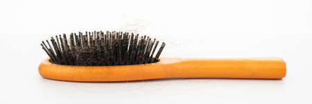 hair loss. wooden comb with burnt hair from stressの写真素材