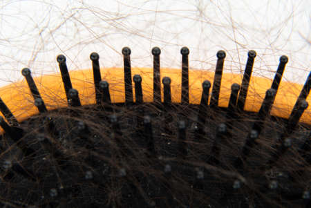 hair loss. wooden comb with burnt hair from stressの写真素材