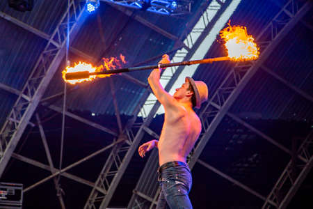 Uzhhorod, Ukraine - April 30, 2018: Feast of Fire. man burns fire. Blurred background of fire seam at the festival.のeditorial素材