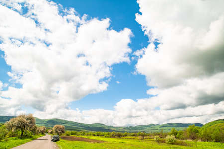 spring weather blue sky with clouds in the countryside.の写真素材