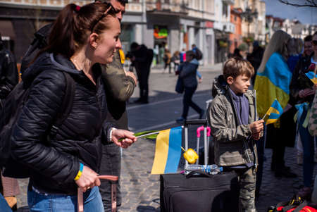 Ukraine. Uzhhorod April 19, 2022: Action in support of Ukraine during the war. Mothers with children with Ukrainian flags and suitcases.aggressionのeditorial素材