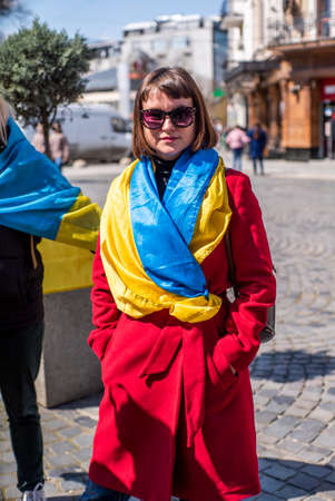 Ukraine. Uzhhorod April 19, 2022: Action in support of Ukraine during the war. Mothers with children with Ukrainian flags and suitcases.aggressionのeditorial素材