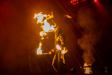 Uzhhorod, Ukraine - April 30, 2018: Feast of Fire. man burns fire. Blurred background of fire seam at the festival.のeditorial素材