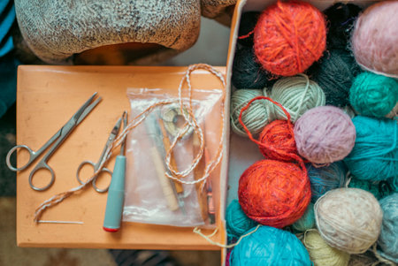 Grandmother knits socks by hand. Digital camera filming commercial video blog or vlog of man teacher vlogger coach recording business device shooting videoblog vlogging conceptの写真素材